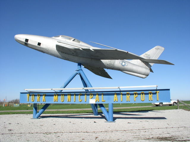 airport entrance with airplane and sign